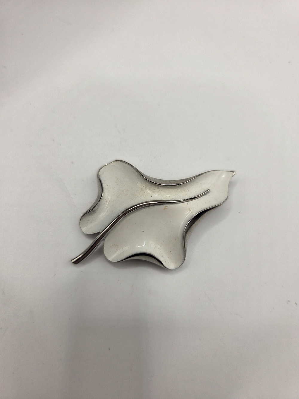 1701.  White Enamel Leaf Brooch with Silver Tone Trim